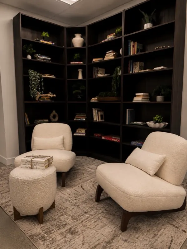 Quiet reading lounge with library shelving and armchairs